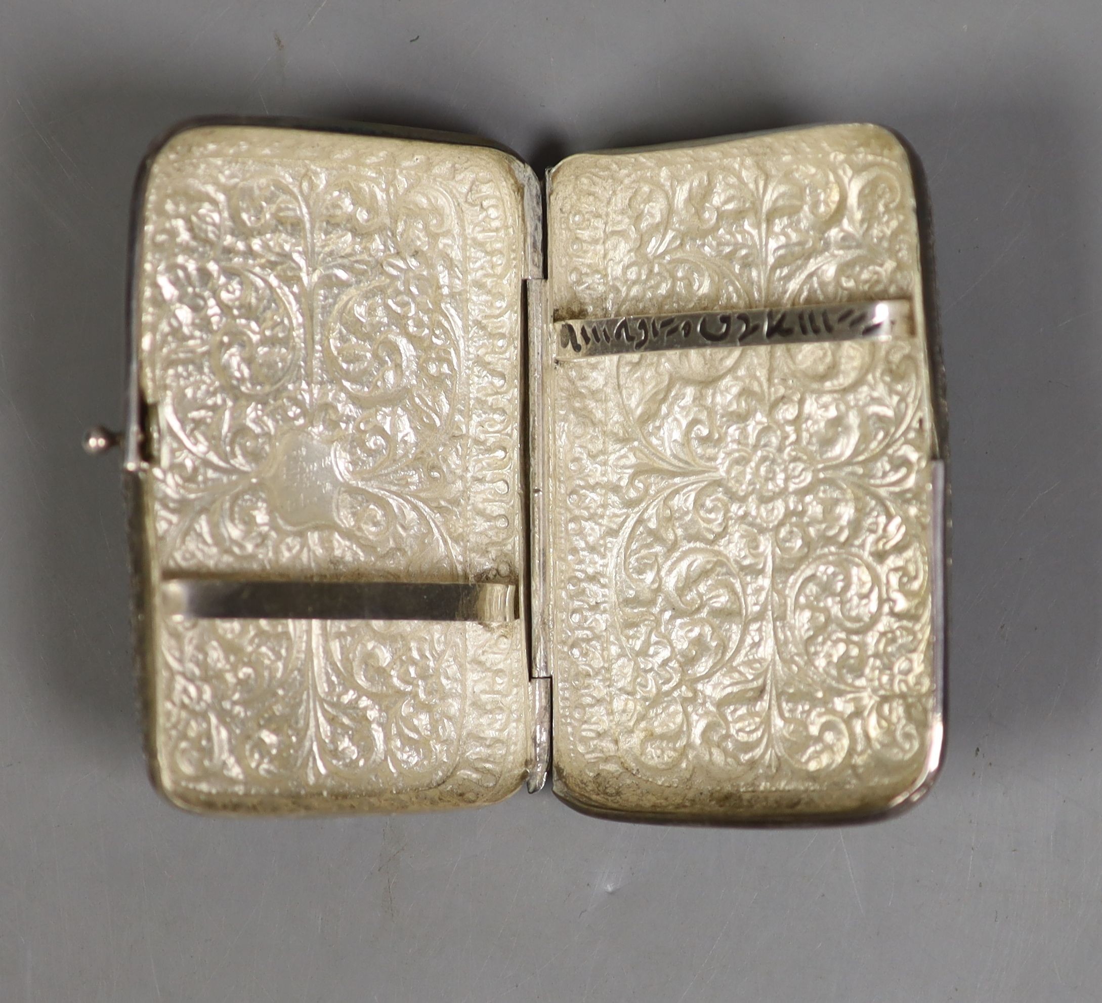 A Persian embossed white metal cigarette case (a.f.), 97mm, 117 grams.